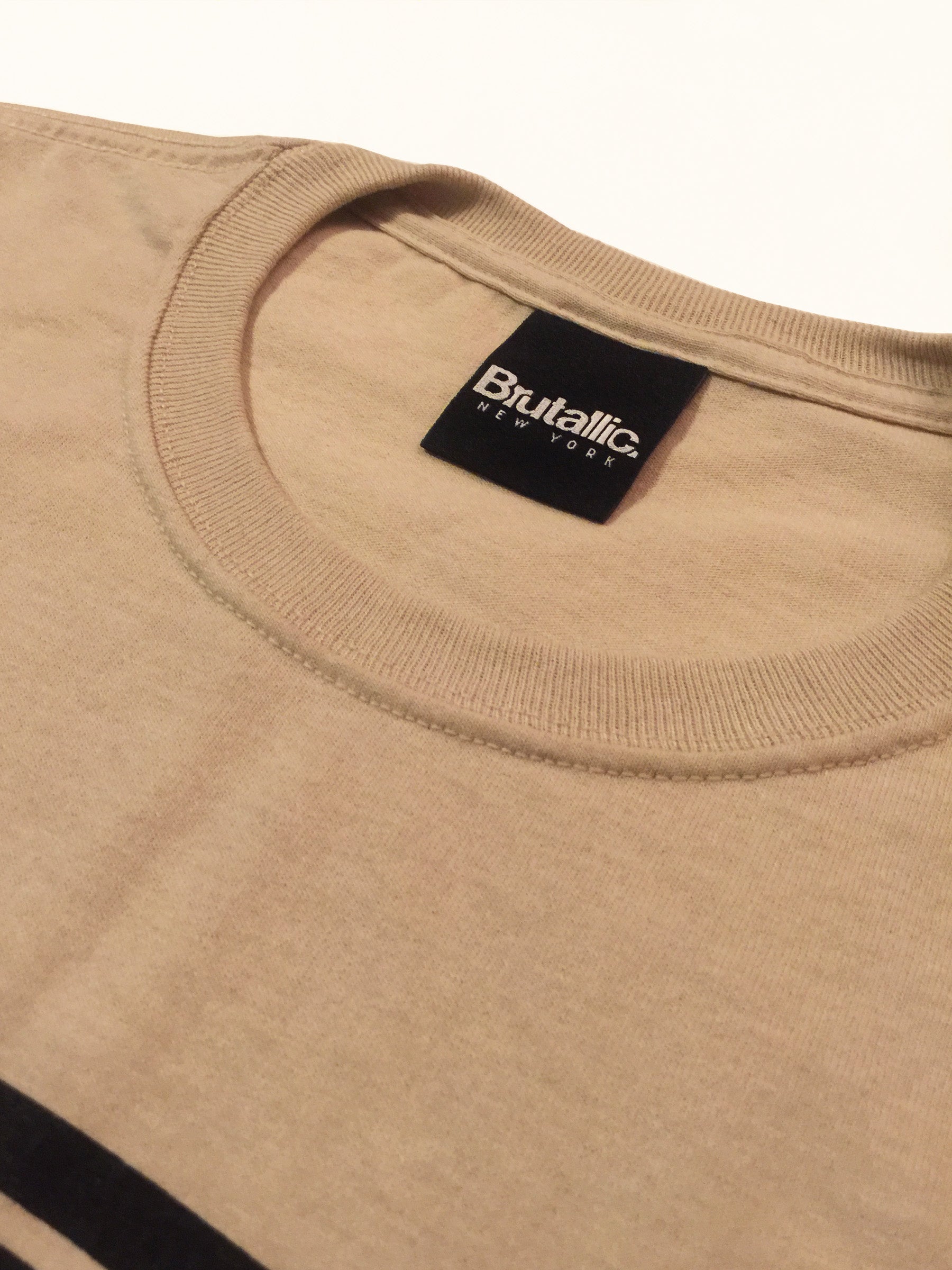 brutallic bubble tee shirt close up of neck label collar with woven neck tag, sand khaki beige color